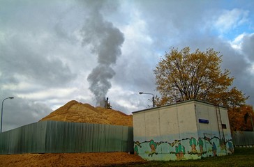 smoke from a pipe against the cloudy sky