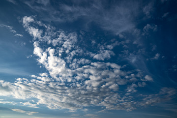 Dramatic evening clouds with in vivid blue sky