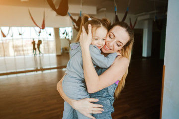 Mother holds her daughter in her arms