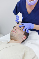 Young man on face treatment
