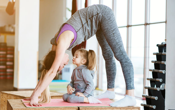 Mom and daughter together perform different exercises