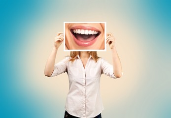 Woman holding picture with big smile. concept photo over dark