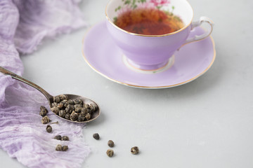 Adderley Bone China Tea Cup and Saucer with Loose Leaf Herbal Tea in Silver Spoon Beside; Grey...