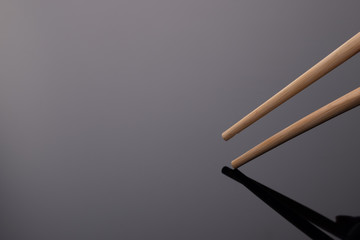 chopsticks on black glossy background