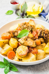 Roasted potato and carrot with lemon, garlic, spicy dressing. Selective focus, space for text.