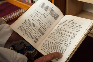 Canberra, ACT, Australia - October 2006: Man reads from English language Quran in Canberra mosque