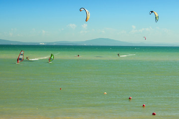 Windsurf and kite surfing action scene in blue sea background