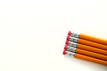 Yellow orange school homework pencils on white background