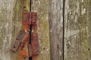 Rusty hinges on rotten doors. Background