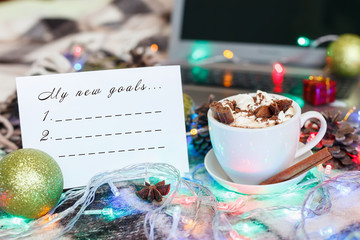 Naklejka na ściany i meble A cup of hot chocolate and marshmallows in Christmas decoration. New Year Goals list.