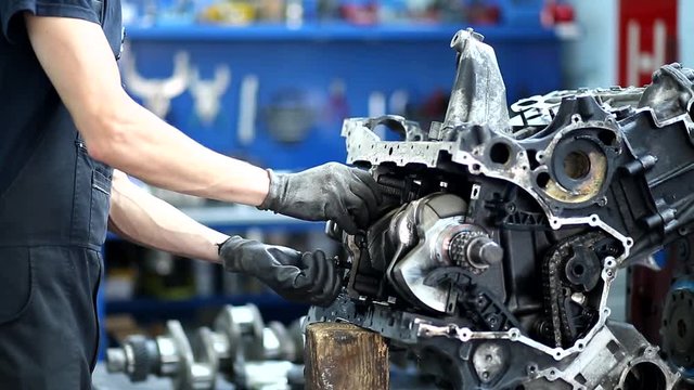 mechanic guy duing engine reparation