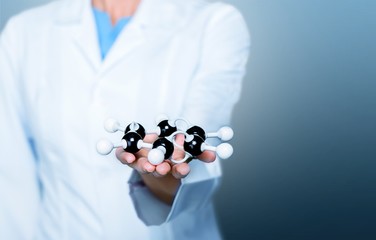 Close up of Molecular structure model in hand on background
