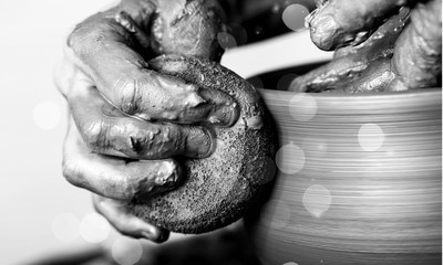 Hand of potter doing  clay pot on background
