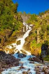 Obraz premium Waterfall Latefossen at sunset lights in summer in Norway