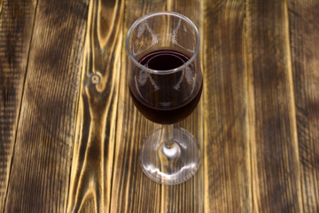 A glass of wine on a wooden background