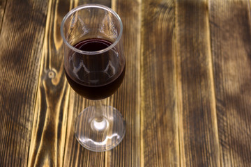 A glass of wine on a wooden background