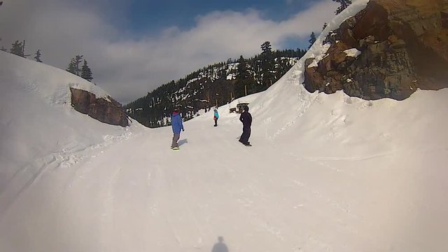 Snowboard group rinding in Whistler, Canada. POV View.