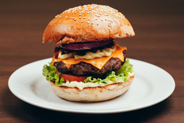 Delicious fresh homemade burger on a wooden table