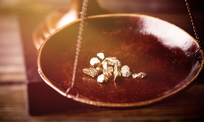 Small gold nuggets in an antique measuring