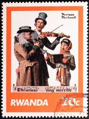 Christmas singers by Norman Rockwell on postage stamp