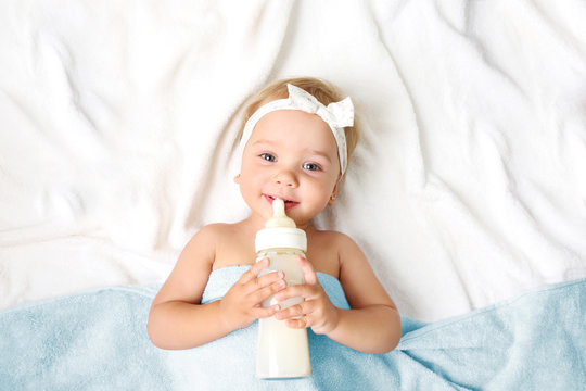 Baby Girl With Milk Bottle Empty Space Background.