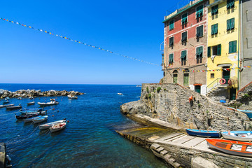 View on the beautiful colourful houses and the floating fishing boats in the harbour of Cinque Terre, Italy. © Spectral-Design