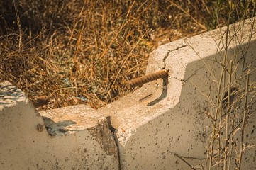 Rusted rebar into a new jersey concrete barrier (Pesaro, Italy, Europe)