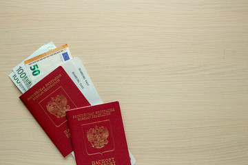 Russian passport, boarding pass and euro on table.