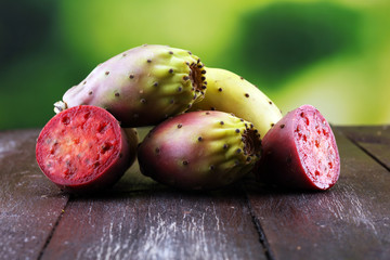 Fruits of the prickly pear cactus on a rustic table.