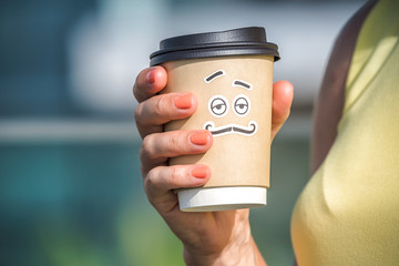 Personified take away coffee cup in woman hand