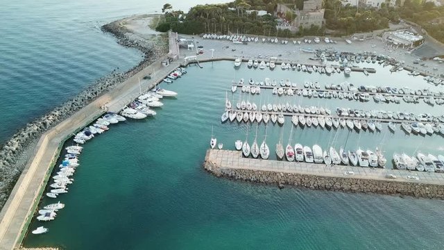 Santa Marinella - Italy. Aerial view of A Small mediterranean marina full of sailboat at sunset