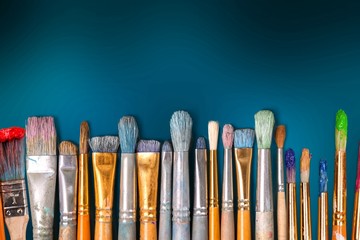 Row of artist paint brushes  on background
