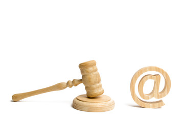 Judge's hammer and email address. The concept of legal proceedings for the seizure of rights to use the names of mail and websites. Confiscation of domain names and e-mail. Rights holders.