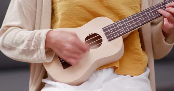 Woman play ukulele
