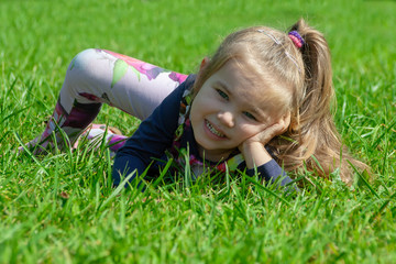 Portrait of a happy little girl in the park