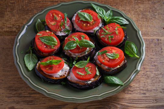 Aubergines with tomatoes and sauce. Pan fried eggplants. Healthy vegetarian food, appetizer. horizontal