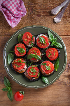 Aubergines with tomatoes and sauce. Pan fried eggplants. Healthy vegetarian food, appetizer. overhead, vertical