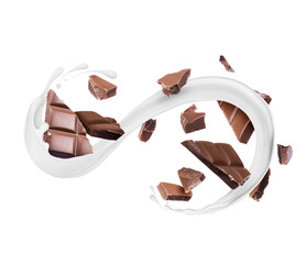 Pieces of chocolate bar with milk splashes, isolated on a white background