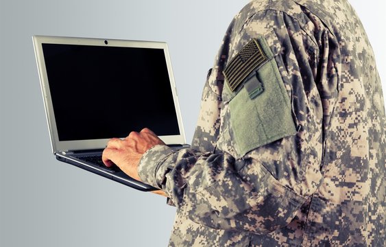 Young Military Soldier Man Portrait With Laptop On  Background