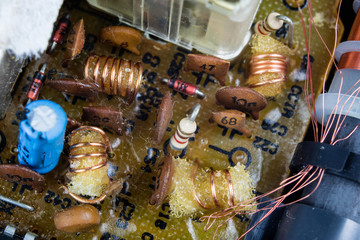 Old integrated circuits in an analog radio receiver. Resistors, transistors and other circuits on...
