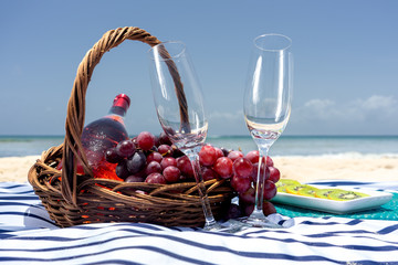 Beach picnic with wine and grapes