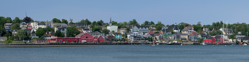 Naklejka premium Panorama of the Lunenburg waterfront and downtown from the other side of the harbor in Nova Scotia
