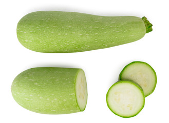 One ripe zucchini, half zucchini and two rings zucchini top view on white background.