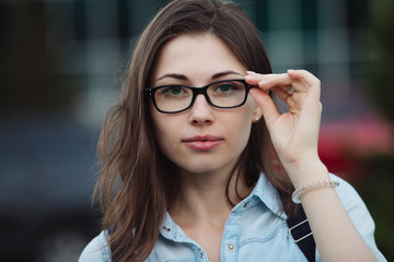 Student girl portrait outdoors closeup in eye glasses for good vision