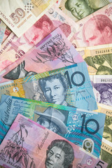 Stylish bright background, made of Australian banknotes, laid out randomly.
