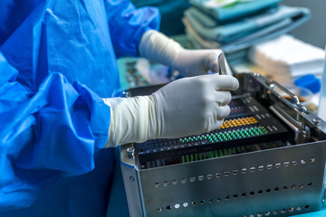 Surgeon's hands with gloves holding pieces