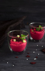 Homemade roasted beet hummus on a dark background. Free space