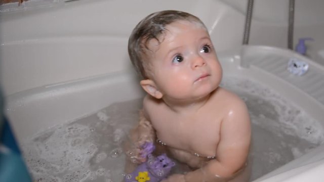 Bath for babies, baby wash your hair. Happy boy taking a bath.