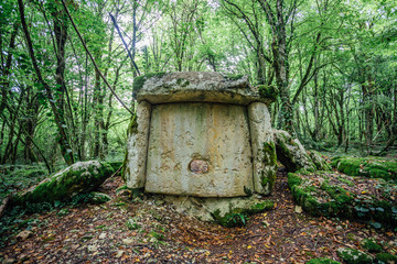 Ancient mysterious megalithic construction dolmen in Abkhazian forest