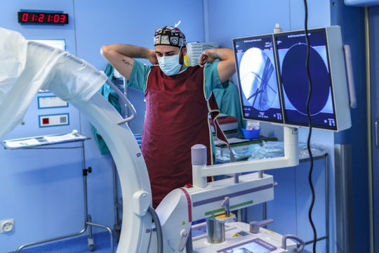 Radiology assistant preparing to take an x-ray inside the operating room